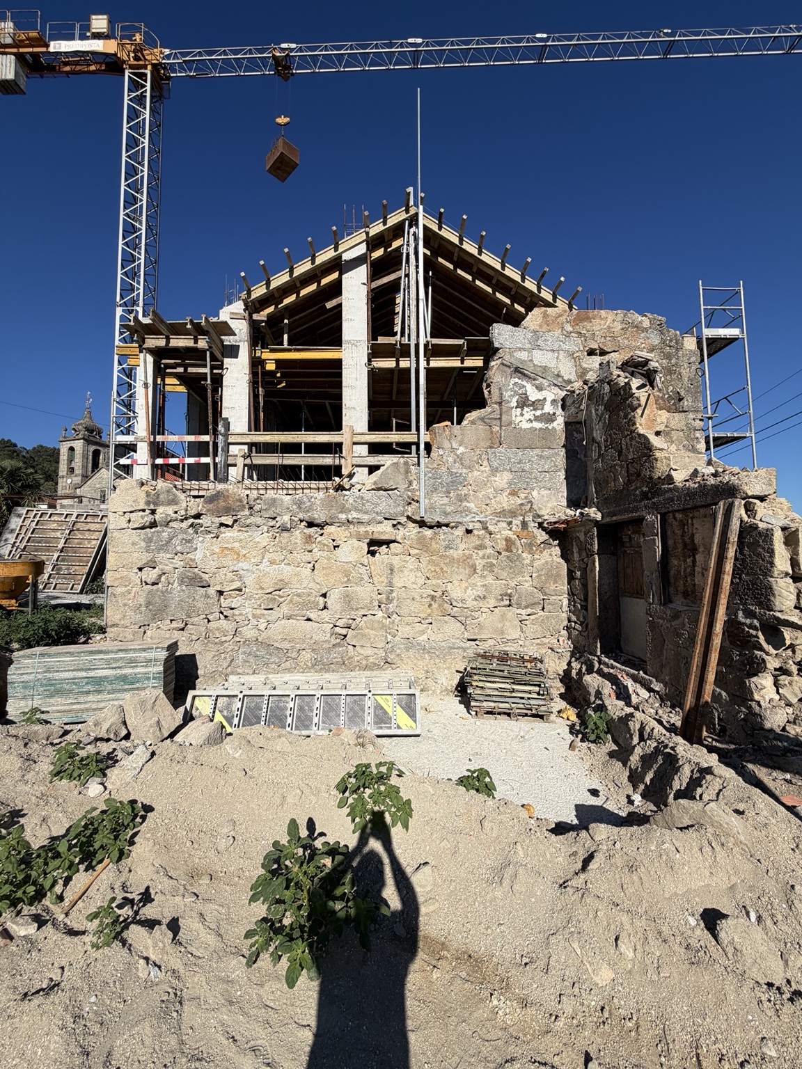 Estrutura da Casa L em construção sobre os muros de pedra existentes